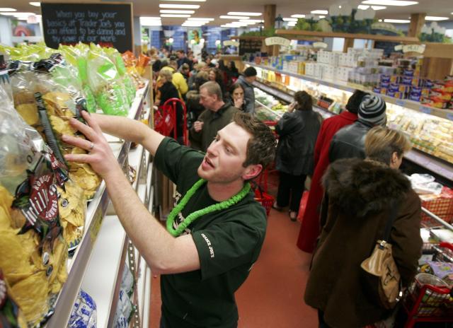 Jason Baglin restocks chips as shoppers line up inside Trader Joe's for the grand opening on 14th Street on March 17, 2006 in New York City. (Photo: Michael Nagle/Getty Images)