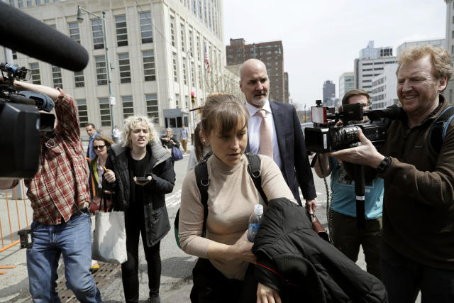 Actress Allison Mack leaves Brooklyn federal court Monday, April 8, 2019, in New York. Mack pleaded guilty to racketeering charges on Monday in a case involving a cult-like group based in upstate New York. The trial is expected to detail sensational allegations that the group, called NXIVM, recruited sex slaves for its spiritual leader, Keith Raniere.(AP Photo/Mark Lennihan)