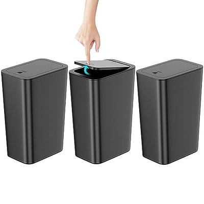 Plastic large trash cans with the lids up and garbage inside