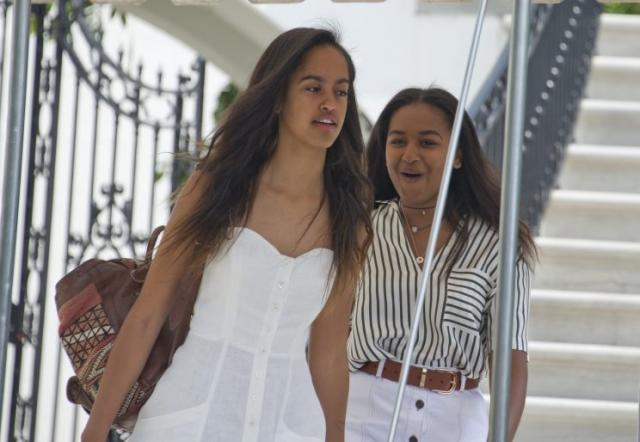 The Obama girls, looking chic and sisterly. (Photo: Getty Images)