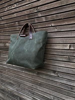 Waxed canvas roll top tote bag with luggage handle attachment