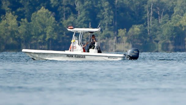 PHOTO: A park ranger patrols an area, July 20, 2018, near where a duck boat capsized the night before resulting in at least 13 deaths near Branson, Mo. (Charlie Riedel/AP)