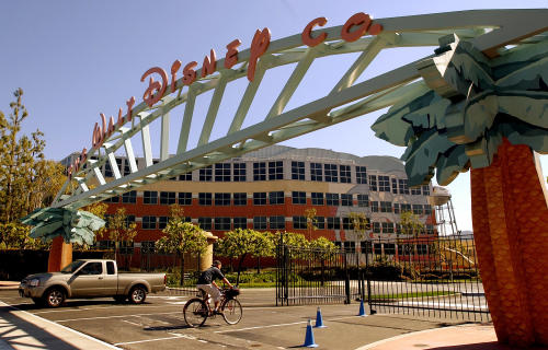 FILE - In this Feb. 11, 2004, file photo, shows the entrance to the Walt Disney Corp. office and studio complex in Burbank, Calif. The European Union announced Thursday, July 23, 2015, that it has opened an antitrust case against six major U.S. movie studios, including Disney, for what it sees as a restriction of trade within the 28-nation bloc because consumers outside Britain and Ireland are prevented from tapping into their products through Sky UK. The other studios include NBCUniversal, Paramount Pictures, Sony, Twentieth Century Fox and Warner Bros. (AP Photo/Reed Saxon, File)