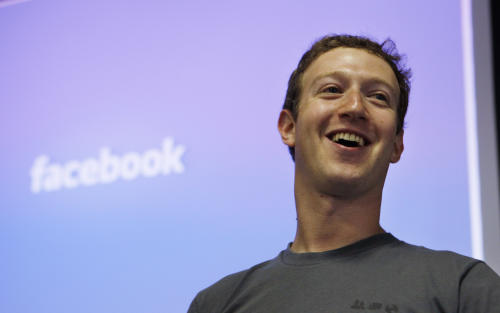 FILE - Facebook CEO Mark Zuckerberg smiles during an announcement at Facebook headquarters in Palo Alto, Calif., in this July 6, 2011 file photo. Facebook and its founder must release documents and electronic correspondence to a defense lawyer whose client has fled from criminal charges that he falsely claimed a majority ownership in the social media giant, a federal judge said Friday April 3, 2015. (AP Photo/Paul Sakuma, File)
