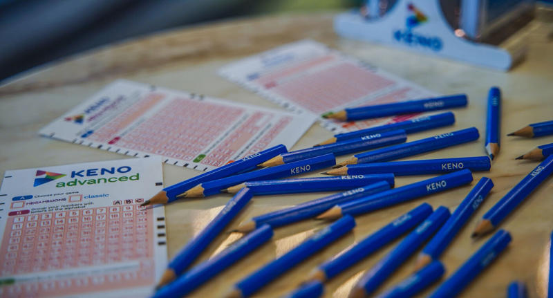 A stock image showing Keno game cards and a pile of pencils.