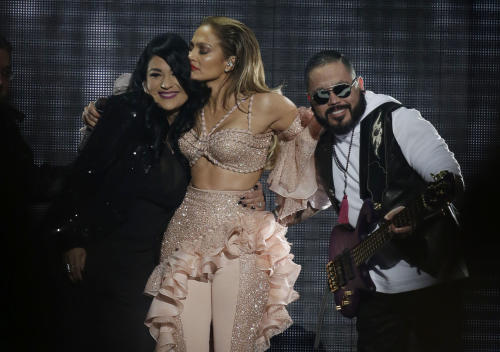 Jennifer Lopez hugs Suzette Quintanilla and A.B. Quintanilla, siblings of slain slinger Selena, during the Latin Billboard Awards Thursday, April 30, 2015, in Coral Gables, Fla. Lopez performed with Selena's band, which included the two siblings. (AP Photo/Lynne Sladky)