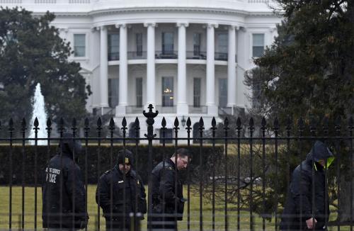 Secret Service officers search the south grounds of the White House in Washington, Monday, Jan. 26, 2015. A device, possibly an unmanned aerial drone, was found on the White House grounds during the middle of the night while President Barack Obama and the first lady were in India, but his spokesman said Monday that it posed no threat. (AP Photo/Susan Walsh)