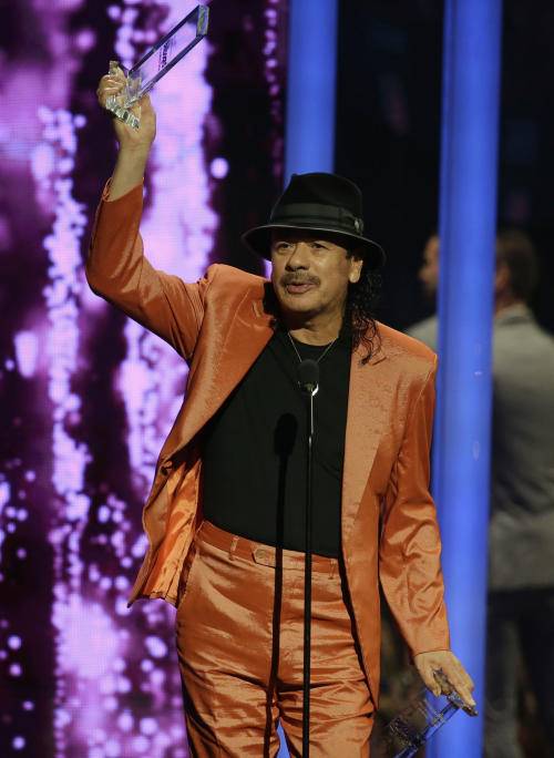 Singer Carlos Santana accepts the Billboard Spirit of Hope Award during the Latin Billboard Awards, Thursday, April 30, 2015 in Coral Gables, Fla. (AP Photo/Lynne Sladky)