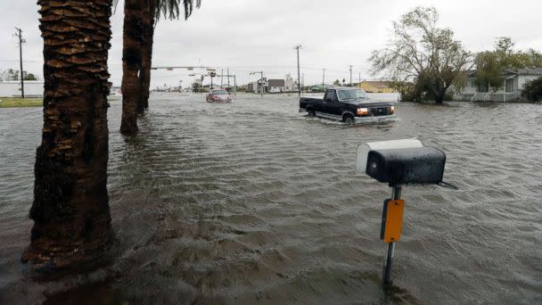 PHOTO: A vehicle moves through flood waters left behind by Hurricane Harvey, Aug. 26, 2017, in Aransas Pass, Texas. (Eric Gay/AP)