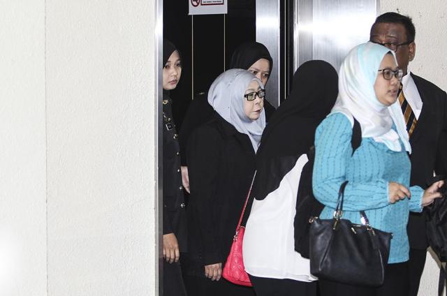 Hasanah (centre) is accused of committing the offence in her previous capacity as a civil servant in the Research Department of the Prime Minister's Office in Putrajaya between April 30 and May 9 this year. â€” Picture by Miera Zulyana