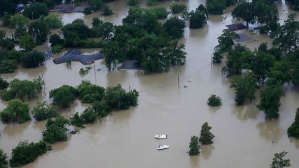 PHOTO: Boaters pass through a neighborhood that has been covered by floodwaters from Tropical Storm Harvey, Aug. 29, 2017, in Houston. (David J. Phillip/AP)