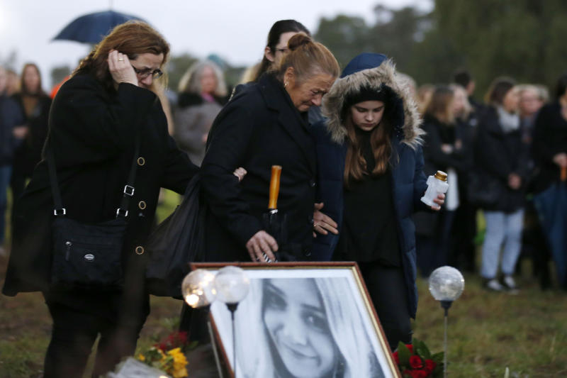 Courtney Herron's family members weep at the scene where her body was found brutally killed. Source: Darrian Traynor/Getty Images