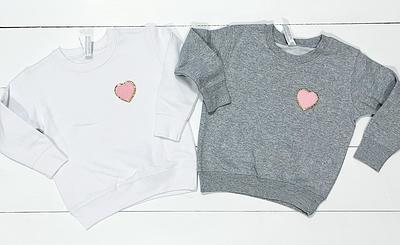 LOVE SWEATSHIRT. Pink with bright red print.