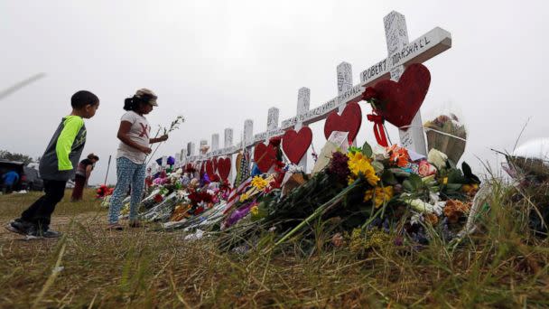 PHOTO: Alexander Osborn and Bella Araiza leave flowers at a makeshift memorial for the victims of the shooting at Sutherland Springs Baptist Church, Nov. 12, 2017, in Sutherland Springs, Texas. (Eric Gay/AP)