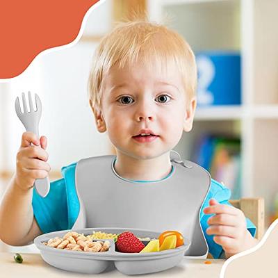 Premium Photo  A small child sits on a highchair and eats food from a  plate with a spoon. baby silicone utensils for feeding babies