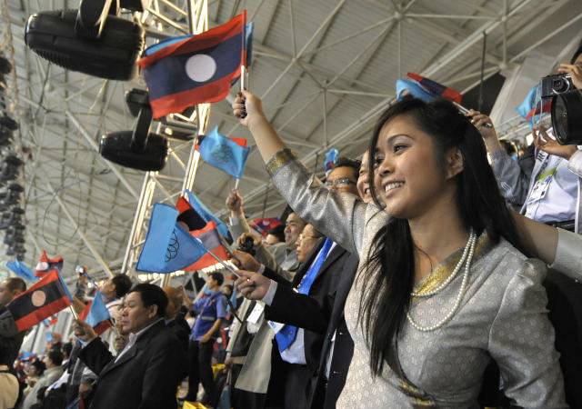 A Lao woman cheers at the opening cerenomy of the 25th Southeast Asian Games (SEAGAMES) in Vientiane on December 9, 2009. The 10-day biennial showpiece officially opened on December 9 in the capital Vientiane, with attention focused on medal hopefuls a head of the Asian Games in China in 2010. The region's biggest sport event will gather athletes from Brunei, Cambodia, Laos, Myanmar, Malaysia, Philippines, Singapore, Thailand, Vietnam, East Timor and Indonesia to compete for 390 gold medals. AFP PHOTO / LIU Jin (Photo credit should read LIU JIN/AFP via Getty Images)