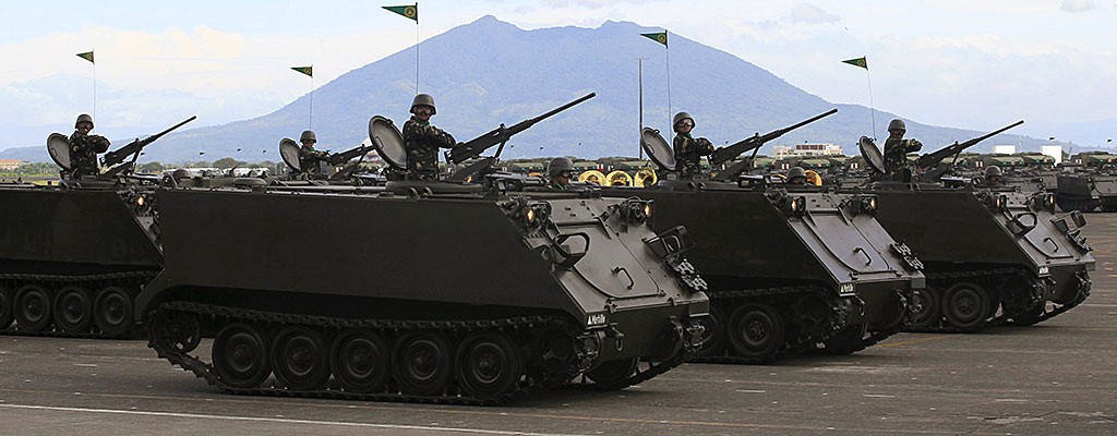 A column of tracked armoured vehicles roll ahead in a parade during the 80th founding anniversary of the Armed Forces of the Philippines held inside Clark Air Base, formerly a U.S. base, in Angeles city, Pampanga province, north of Manila December 21, 2015 (REUTERS/Romeo Ranoco)