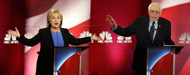 Hillary Clinton and Sen. Bernie Sanders talk over each other during the Democratic presidential primary debate. (Mic Smith/AP)