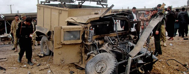 Afghan security forces inspect the site of a roadside bomb explosion in Lashkar Gah, the capital of Helmand province, southern Afghanistan. (Abdul Khaliq/AP)