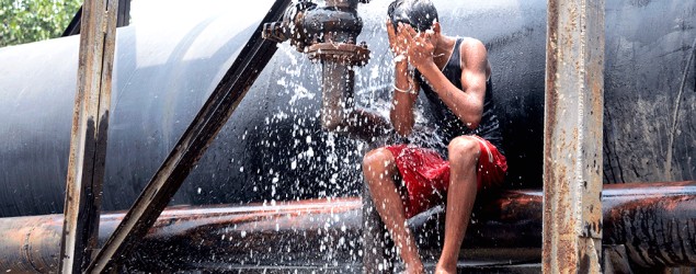 People bath using a KMC water pipe as the mercury heat wave rises in Kolkata and other parts of India. (Saikat Paul/Pacific Press/LightRocket via Getty Images)