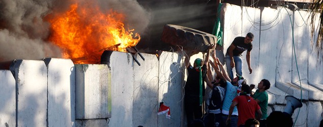 Palestinians set a fire into an Israeli army outpost during the funeral of three Palestinians. (Reuters)