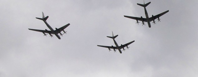 People watch as Tu-95 strategic bombers fly over downtown Moscow during a parade rehearsal. (Ivan Sekretarev/AP)