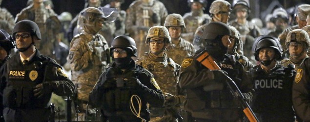 Police and Missouri National Guardsmen stand guard in front of Ferguson Police Department on Nov. 28 in Ferguson, Mo. (Jeff Roberson/AP)