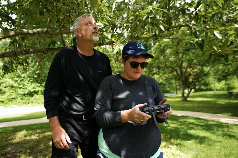 Brent Walls, left, the Upper Potomac Riverkeeper with Potomac Riverkeeper Network, overlooks as Cara Schildtknecht, the Waccamaw Riverkeeper with Winyah Rivers Alliance, pilots her first-ever drone flight during a training session, Tuesday, June 7, 2022, in Poolesville, Md. Schildtknecht said a drone will help her see areas in her watershed that are hard to reach by boat, record floods and find polluters. (AP Photo/Julio Cortez)