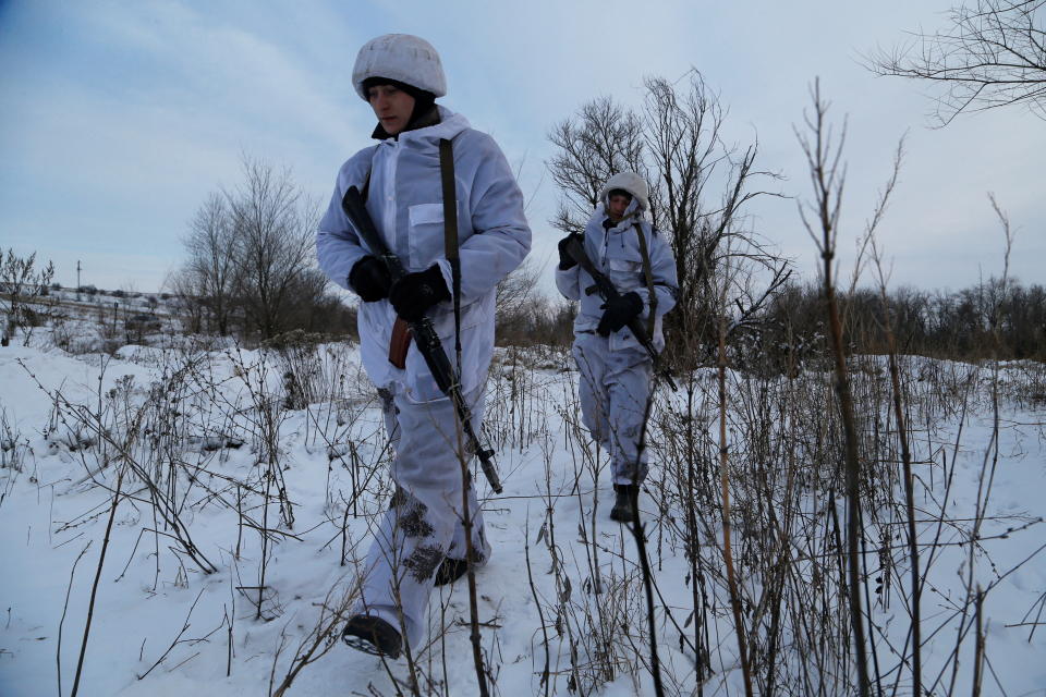 Militants of the self-proclaimed Luhansk People's Republic walk at a fighting position on the line of separation from the Ukrainian armed forces near the settlement of Frunze in Luhansk Region, Ukraine December 24, 2021. REUTERS/Alexander Ermochenko