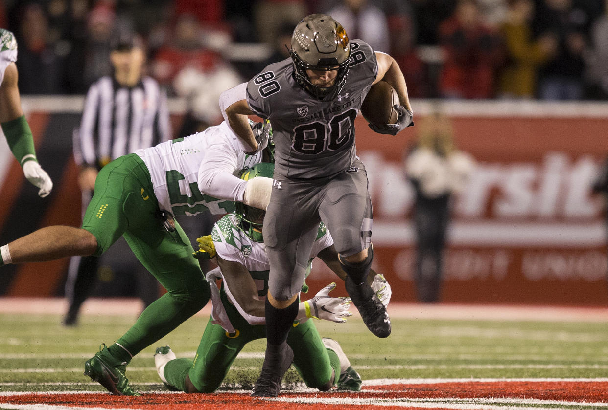 SALT LAKE CITY, UT -  NOVEMBER 20: Brant Kuithe #80 of the Utah Utes breaks a tackle attempt by Jordan Happle #32 of the Oregon Ducks during their game November 20, 2021 at Rice-Eccles Stadium in Salt Lake City , Utah. (Photo by Chris Gardner/Getty Images)