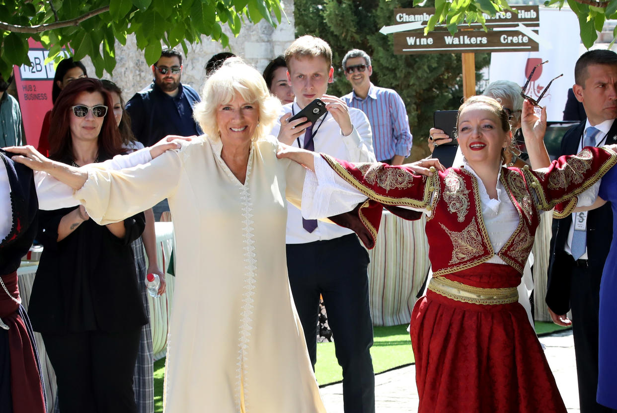 CRETE, GREECE - MAY 11:  Camilla, Duchess of Cornwall takes part in a traditional dance at Church Square on May 11, 2018 in Crete, Greece.  (Photo by Chris Jackson/Getty Images)