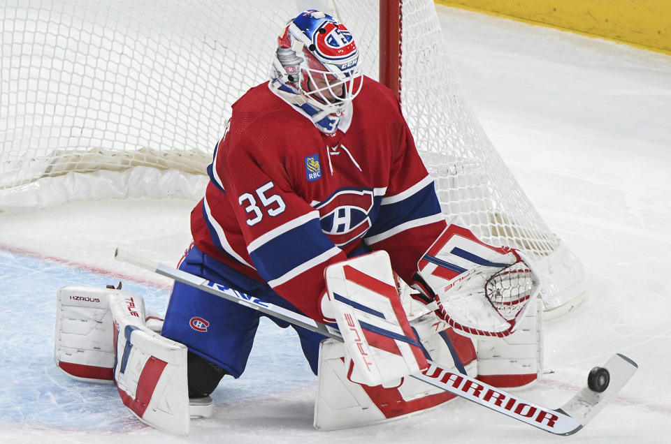 Montreal Canadiens goaltender Sam Montembeault makes a save against the New York Islanders during the first period of an NHL hockey match in Montreal, Saturday, Dec. 16, 2023. (Graham Hughes/The Canadian Press via AP)