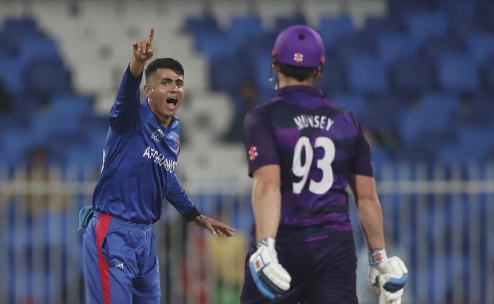 Afghanistan's Mujeeb Ur Rahman appeals successfully the dismissal of Scotland's Richie Berrington during the Cricket Twenty20 World Cup match between Afghanistan and Scotland in Sharjah, UAE, Monday, Oct. 25, 2021. (AP Photo/Aijaz Rahi)