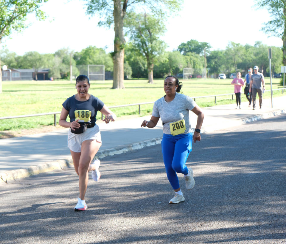 Two runners push themselves toward the finish of the Chief Petty Officer Jack R. Barnes Run For the Fallen Saturday morning at Stephen F Austin Park in Amarillo.
