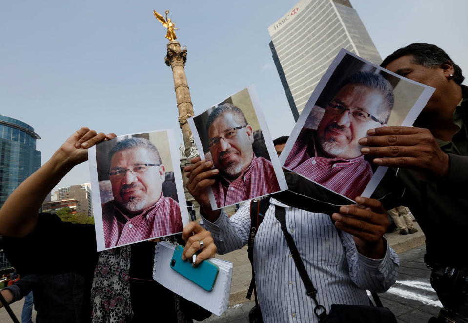 <p>Journalists and photographers hold up pictures of journalist Javier Valdez during a demonstration against his killing and for other journalists who were killed in Mexico, at the Angel of Independence monument in Mexico City, Mexico May on 16, 2017. (Henry Romero/Reuters) </p>