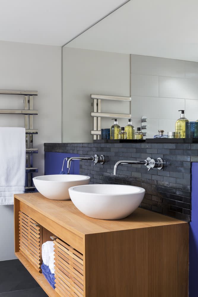 <p>Here, a classic teak cupboard provides a useful place to store bathroom essentials, while black slate tiles create an eye-catching statement. </p><p><a class="link " href="https://www.housebeautiful.com/uk/renovate/homes-makeovers/a1196/barn-conversion-renovation-modern-family-home/" rel="nofollow noopener" target="_blank" data-ylk="slk:TAKE A TOUR;elm:context_link;itc:0;sec:content-canvas">TAKE A TOUR</a></p>