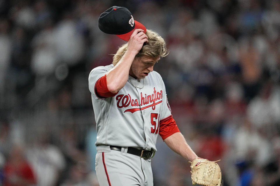 Washington Nationals relief pitcher Jordan Weems scratches his head after he was relieved in the fifth inning of a baseball game against the Atlanta Braves, Saturday, Sept. 30, 2023, in Atlanta. (AP Photo/John Bazemore)
