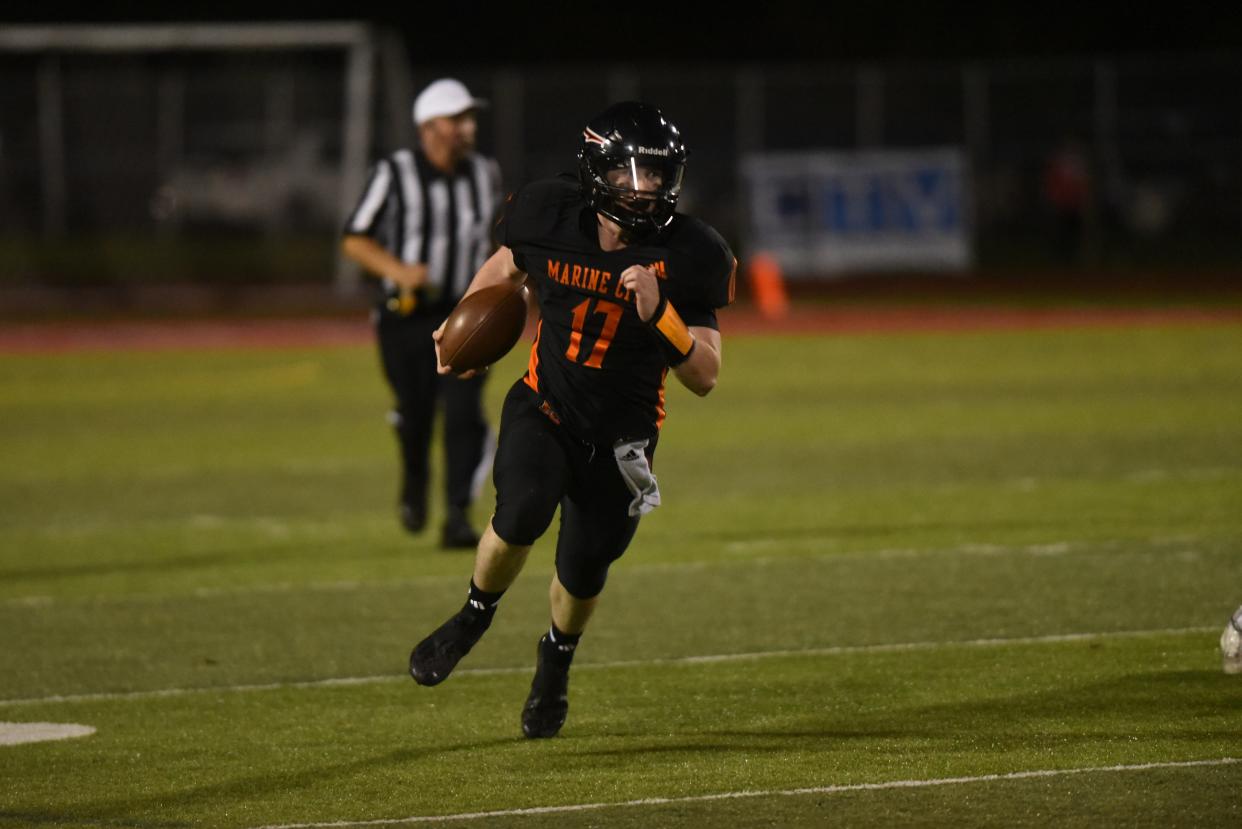 Marine City's Parker Atkinson carries the ball on a keeper during a Division 5 district semifinal against Richmond at East China Stadium on Friday, Oct. 27, 2023.