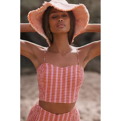 model wearing gingham crop top in pink, orange and red with matching shorts