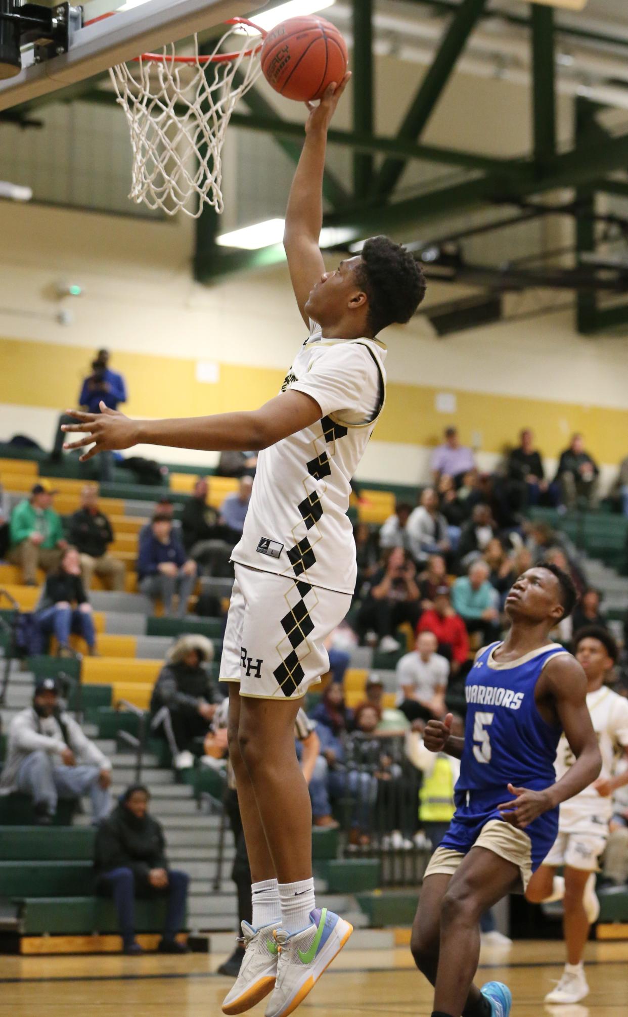 Rush-Henrietta's Jalen Taggart drives in for two as he scores on a fast break ahead of Schroeder's Aydin Stephens.