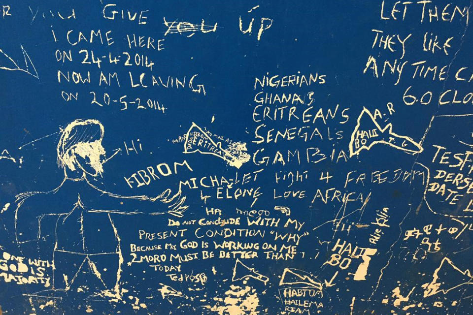 Messages are scrawled on a wall in the Gharyan Detention Center in Libya. (The Outlaw Ocean Project)