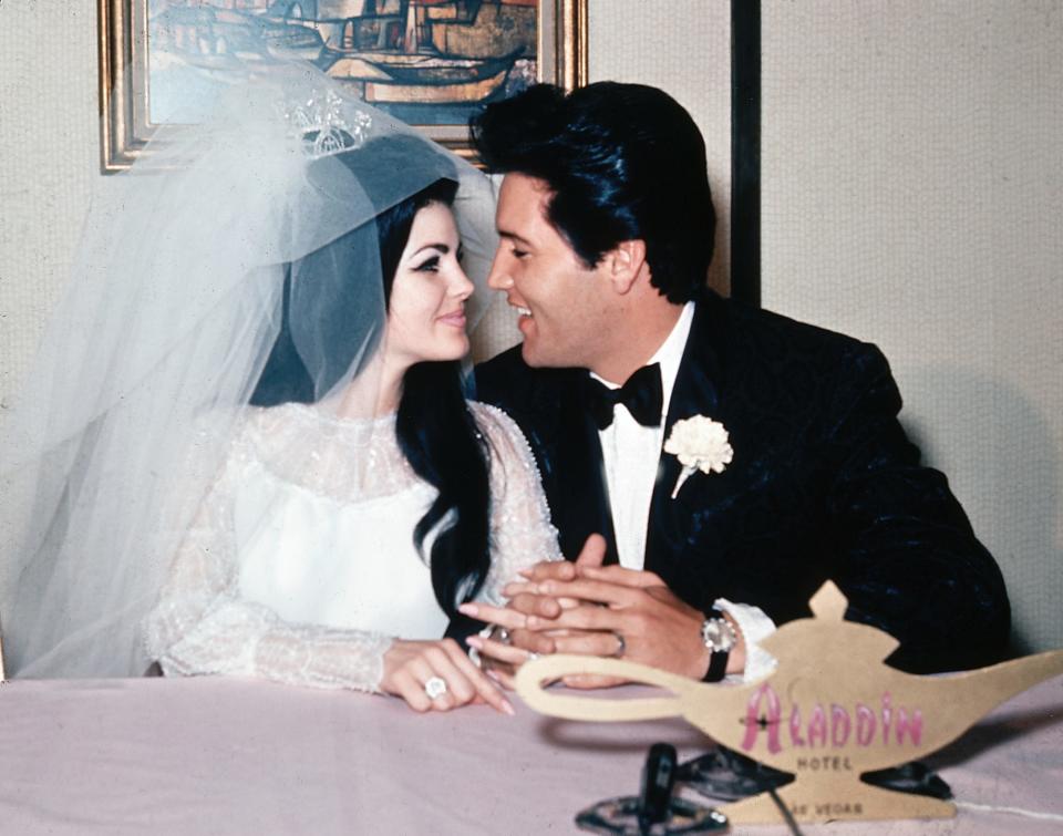 Elvis Presley and his bride, the former Priscilla Beaulieu, are shown at the Aladdin Hotel in Las Vegas, Nevada after their wedding on May 1, 1967. Presley, 32, and Beaulieu, 21, met while he was stationed in Germany with the U.S. Army. 