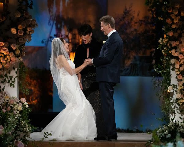 <p>John & Joseph Photography/disney</p> Theresa Nist and Gerry Turner on the altar with officiant Susan Noles at the Golden Wedding