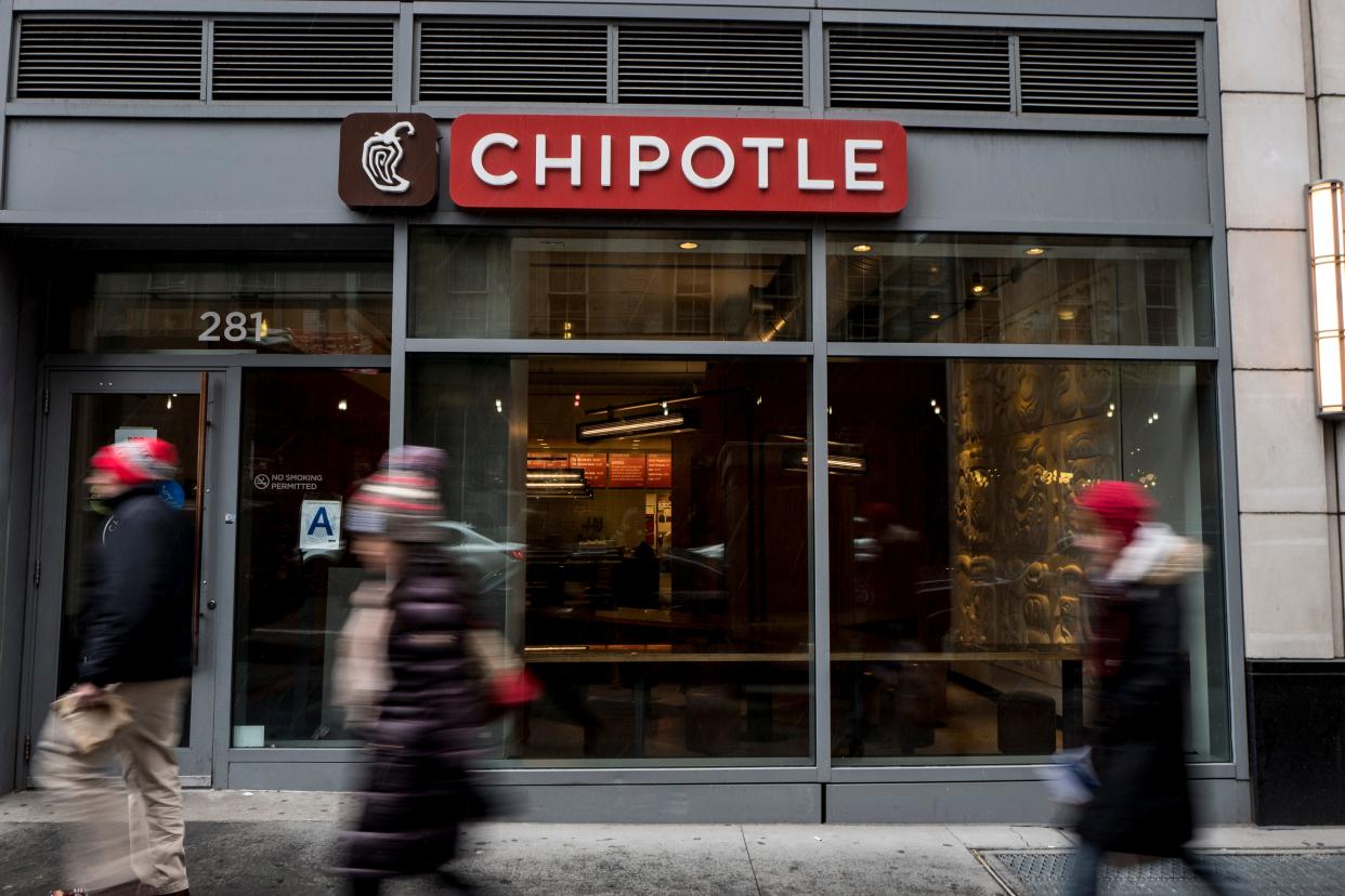 People walk past a Chipotle restaurant in NYC.