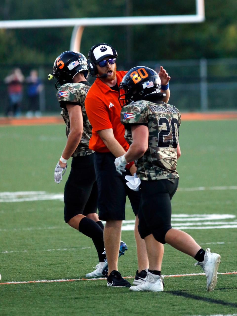 Coach Kevin Board congratulates running back Hunter Rose after he scored a touchdown during New Lexington's 38-18 win against visiting Maysville on Friday night at Jim Rockwelll Stadium.