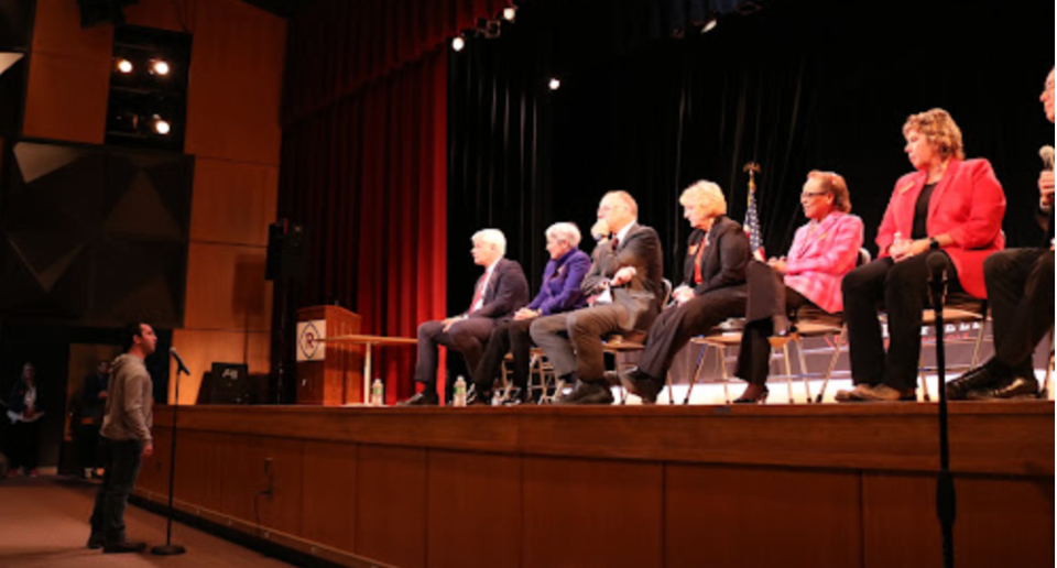 Associate Justice Paul Thissen, on stage to the left, earned raucous applause when he announced that his mother used to teach at Richfield High School. (Courtesy Minnesota Judicial Branch)