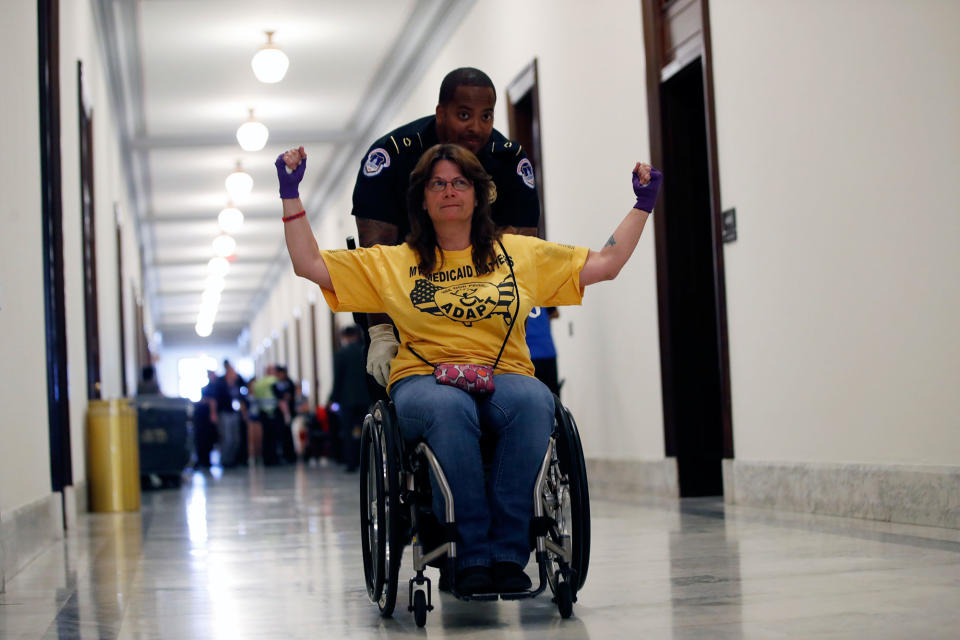 <p>A protestor is removed from a sit-in outside of Senate Majority Leader Mitch McConnell’s office where they protested proposed cuts to Medicaid, Thursday, June 22, 2017 on Capitol Hill in Washington. (Photo: Jacquelyn Martin/AP) </p>