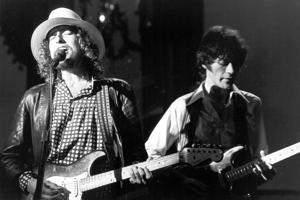 SAN FRANCISCO - NOVEMBER 25: Bob Dylan and Robbie Robertson perform on stage for 'The Band's' 'The Last Waltz' concert at the Winterland Ballroom on November 25, 1976 in San Francisco, California. (Photo by Larry Hulst/Michael Ochs Archives/Getty Images)