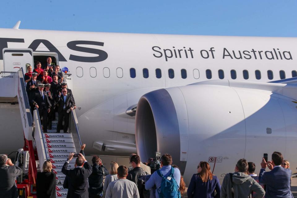 Qantas Group CEO Alan Joyce and crew exit the aircraft upon landing (QANTAS/AFP via Getty Images)