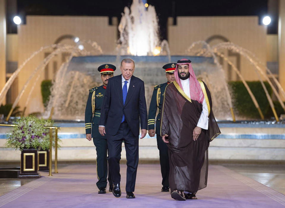 In this photo released by the state-run Saudi Press Agency, Turkish President Recep Tayyip Erdogan, left, and Saudi Crown Prince Mohammed bin Salman walk during a welcome ceremony at Al Salam Palace in Jeddah, Saudi Arabia, Monday, July 17, 2023. Erdogan traveled to Saudi Arabia on Monday in a three-stop tour of Gulf states to seek trade and investment opportunities for Turkey's floundering economy. (Saudi Press Agency via AP)